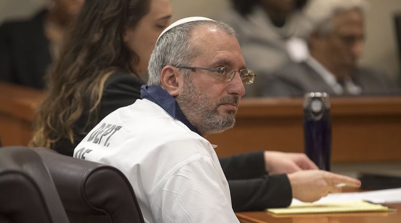Hemy Neuman sits with his attorneys during his motion for a new trial in front of DeKalb County Judge Gregory Adams at the DeKalb County Courthouse in Decatur on July 9, 2019. (Alyssa Pointer/AJC FILE ART)