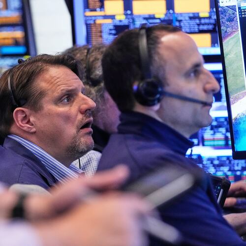 Trader Michael Milano, center, works with colleagues on the floor of the New York Stock Exchange, Wednesday, May 13, 2026. (AP Photo/Richard Drew)