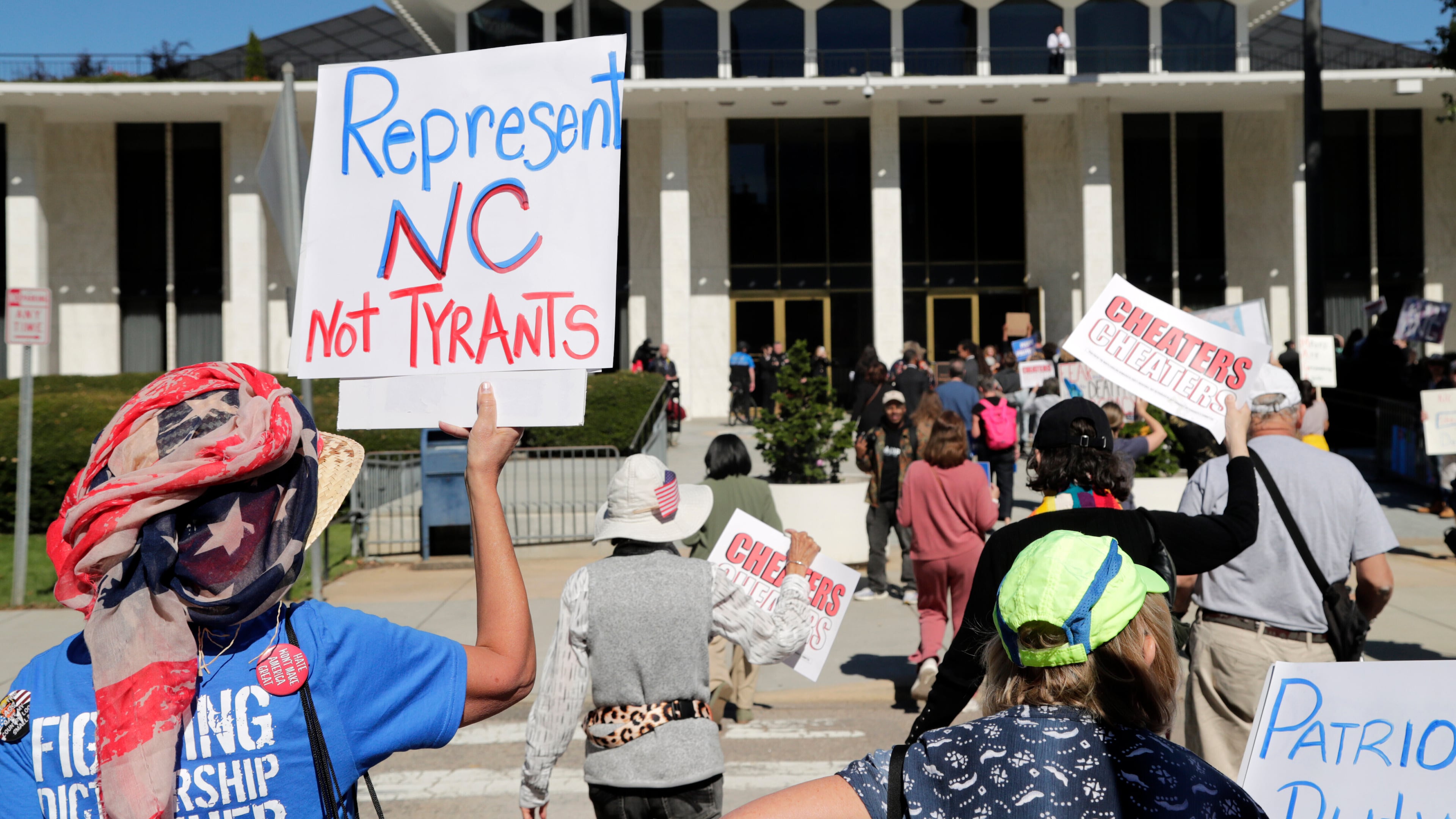 FILE - Demonstrators approach the Legislative Building during a rally protesting a proposed election redistricting map, Oct. 21, 2025, in Raleigh, N.C. (AP Photo/Chris Seward)