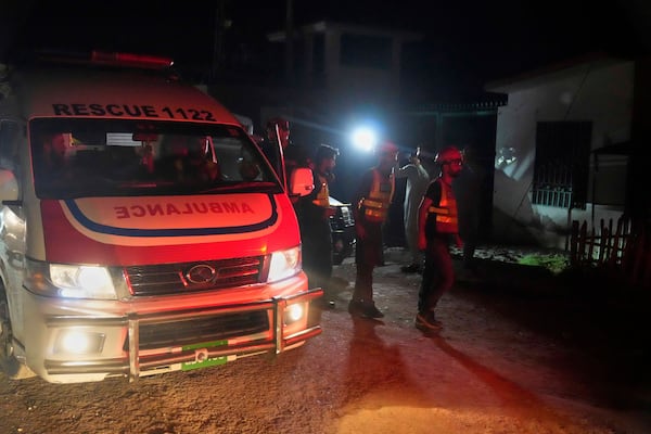 Rescue workers and an ambulance arrive at the site of a suspected Indian missile attack, in Muridke, a town in Pakistan's Punjab province, Wednesday, May 7, 2025. (AP Photo/K.M. Chaudary)