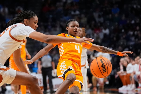 Tennessee guard Kaniya Boyd (4) and Texas forward Madison Booker chase down a loose ball during the second half in the Sweet 16 of the NCAA college basketball tournament, Saturday, March 29, 2025. in Birmingham, Ala. (AP Photo/Gerald Herbert)