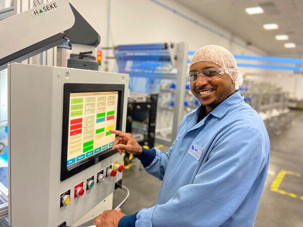 Machine operator Archie Reed closes out a production run of a material used in the manufacture of commercial aircraft at Web Industries' facility in Suwanee. Courtesy Web Industries Inc.