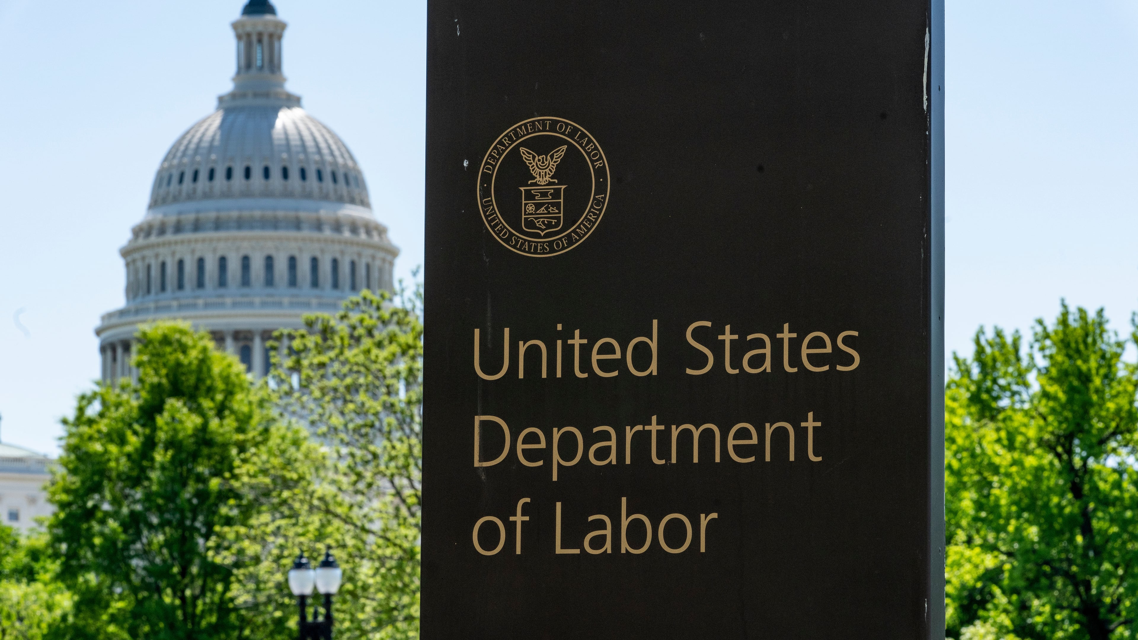 FILE - In this May 7, 2020, file photo, the entrance to the Labor Department is seen near the Capitol in Washington. (AP Photo/J. Scott Applewhite, File)
