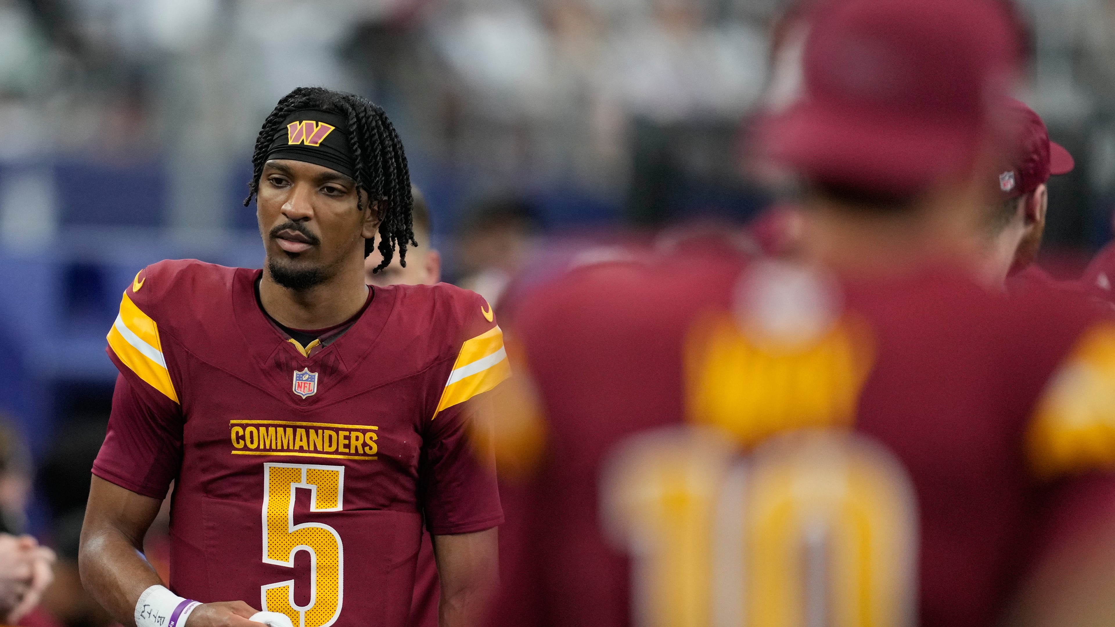 Washington Commanders quarterback Jayden Daniels walks on the sideline during the first half of an NFL football game against the Dallas Cowboys Sunday, Oct. 19, 2025, in Arlington, Texas. (AP Photo/Tony Gutierrez)