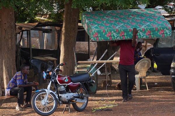 A man carries belongings and prepares to leave following an attack by gunmen in Yelewata community north-central Nigeria, Monday, June 16, 2025. (AP Photo)