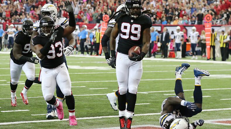Falcons defensive end Adrian Clayborn recovers a fumble by Chargers quarterback Philip Rivers on a sack by Vic Beasley Jr. and returns it for a touchdown for a 27-10 lead during the second quarter in an NFL football game on Sunday, Oct. 23, 2016, in Atlanta. Curtis Compton /ccompton@ajc.com