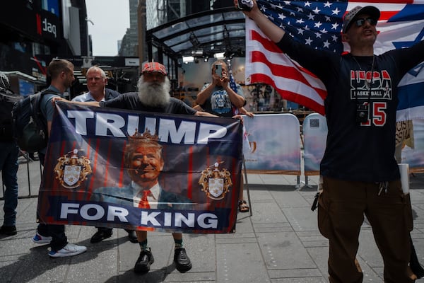 Supporters of President Donald Trump hold pro-Trump flags in Times Square during a protest against U.S. strikes on Iran, Sunday, June 22, 2025, in New York. (AP Photo/Olga Fedorova)