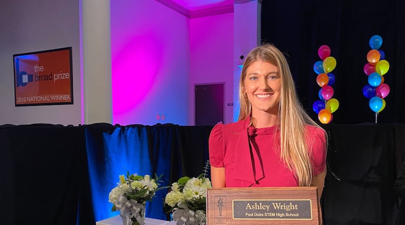 Ashley Wright, a graphic design teacher at Paul Duke STEM High School, poses with her award for being named teacher of the year in Gwinnett County Public Schools.
