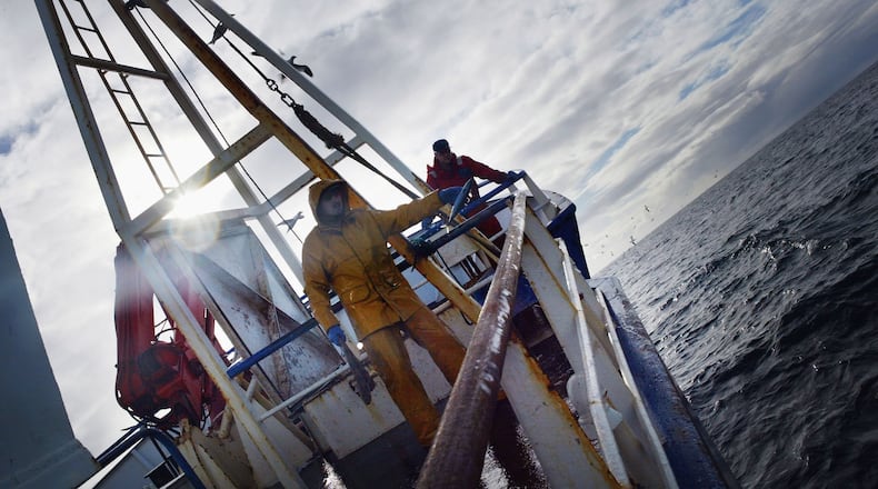 Fisherman are pictured here on a commercial fishing vessel, like one that was lost on the Bering Sea last weekend. The crew of the cable reality show 'Deadliest Catch' knew the crew of the crabbing boat Destination and are mourning the loss.