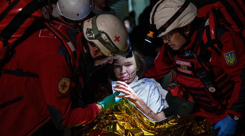 Red Cross volunteers help an injured woman in a shelter after a Russian strike on a residential neighborhood in Kyiv, Ukraine, on Sunday, May 24, 2026. (AP Photo/Evgeniy Maloletka)
