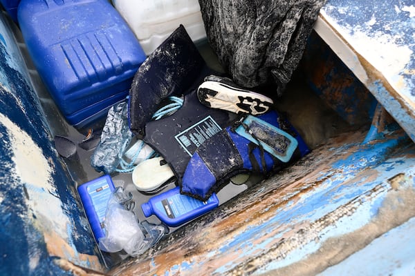Life jackets and personal items are seen in a boat that capsized Monday, May 5, 2025, at Torrey Pines State beach in San Diego. (AP Photo/Denis Poroy)