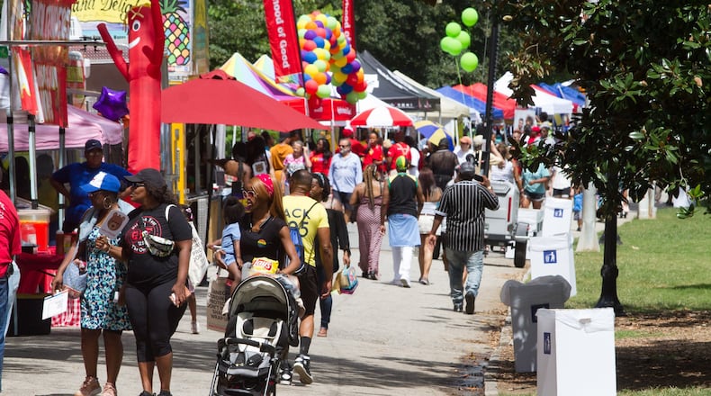 People walk past the vendor booths during the Pure Heat Community Festival during Atlanta Black Pride weekend in 2019. STEVE SCHAEFER / SPECIAL TO THE AJC