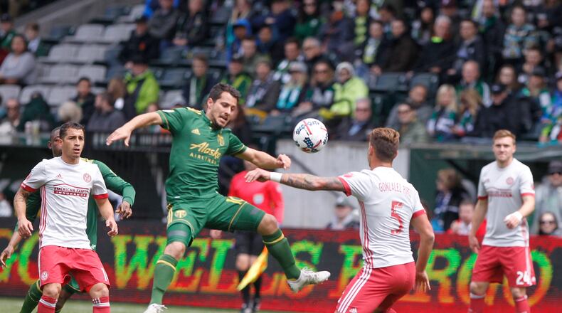 Portland’s Sebastian Blanco, center, tries to corral the ball as Atlanata’s Leandro Gonz’lez Pirez (5) defends as the Portland Timbers hosted Atlanta United FC in a MLS match at in Portland, Ore., Sunday, May 14, 2017. (Sean Meagher/The Oregonian via AP)