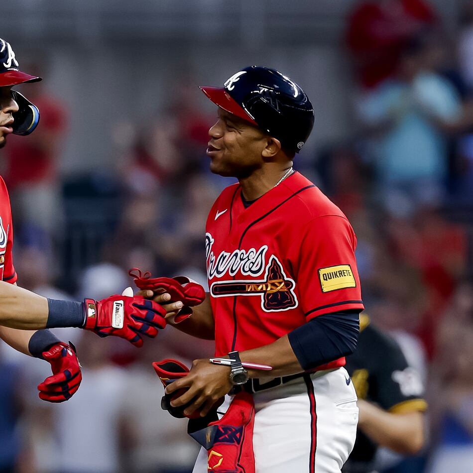 Atlanta Braves' Mauricio Dubon, left, reacts with first base coach Antoan Richardson, right, after hitting an RBI double against the Pittsburgh Pirates during the fifth inning of a baseball game, Friday, June 5, 2026, in Atlanta. (Erik S. Lesser/AP)