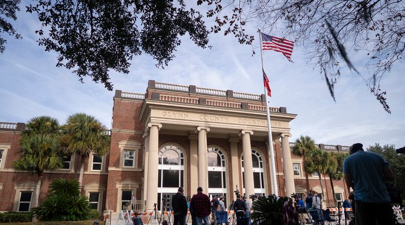 People gather outside the Glynn County Courthouse in Brunswick, Ga. on Monday, Nov. 22, 2021, as closing arguments are delivered in the murder of Ahmaud Arbery. Arbery, a 25-year-old Black man, was chased through a Brunswick, Ga., suburb and fatally shot at close range on Feb. 23, 2020. (Nicole Craine/The New York Times)