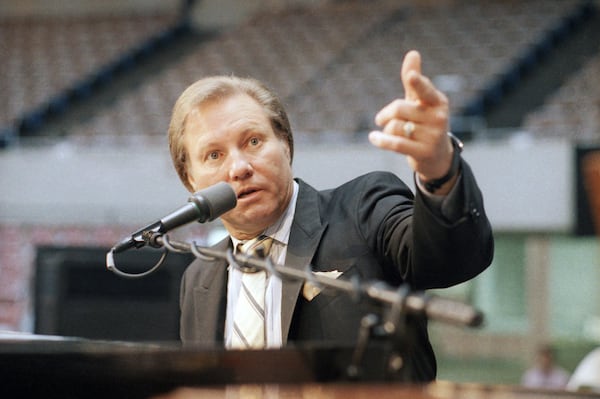 FILE - Rev. Jimmy Swaggart raises his fist to make point at news conference at the Sports Arena in Los Angeles, Friday, March 27, 1987. (AP Photo/Lennox McLendon, file)