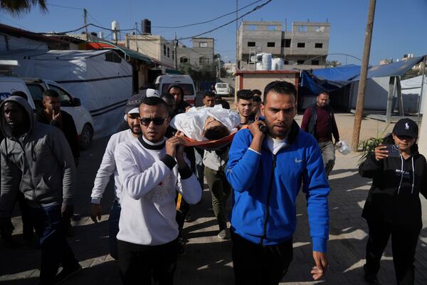 Mourners carry the bodies of Palestinians killed in the Israeli bombardment of the Gaza Strip as they are brought for burial Deir al-Balah, Gaza, Sunday, March 30, 2025. (AP Photo/Abdel Kareem Hana)