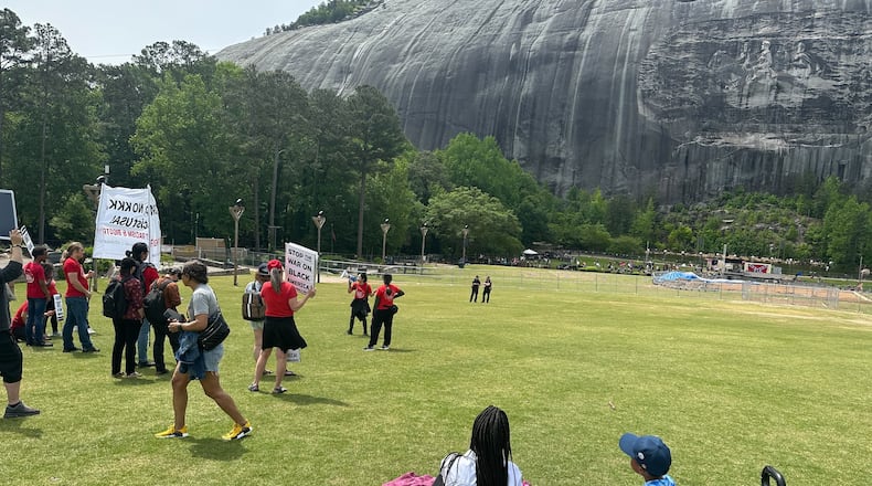 Visitors sit on the lawn in front of the monument at Stone Mountain on April 29, 2023. (Rodney Ho/AJC)