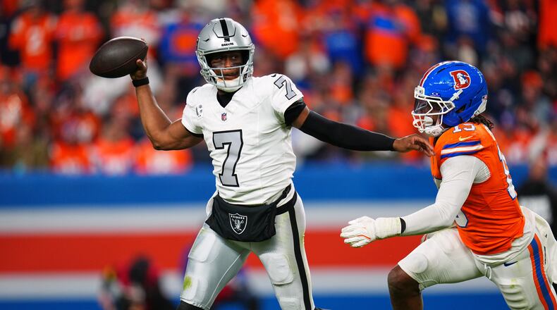 Las Vegas Raiders quarterback Geno Smith (7) throws under pressure from Denver Broncos outside linebacker Nik Bonitto (15) during the second half of an NFL football game Thursday, Nov. 6, 2025, in Denver. (AP Photo/Jack Dempsey)