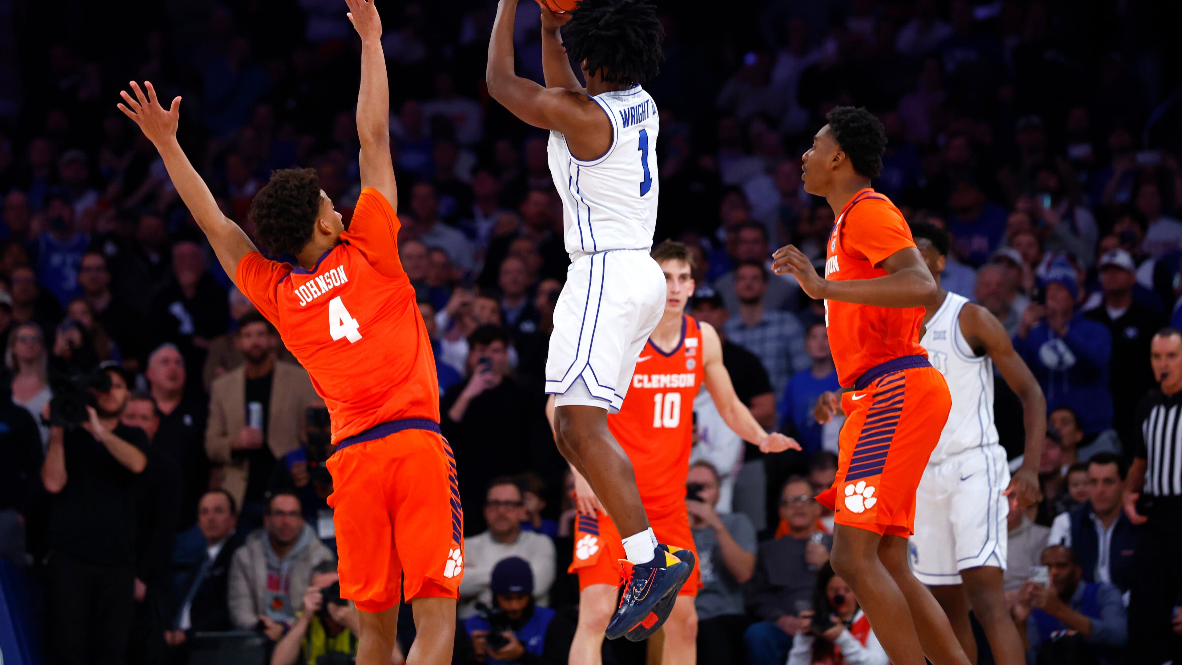 BYU guard Robert Wright III (1) makes the game winning shot against Clemson guard Efrem Johnson (4) during the second half of an NCAA basketball game, Tuesday, Dec. 9, 2025, in New York. (AP Photo/Noah K. Murray)