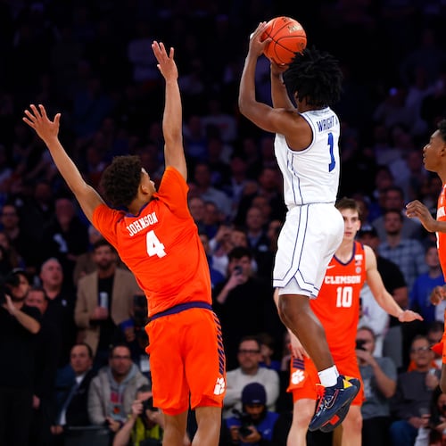 BYU guard Robert Wright III (1) makes the game winning shot against Clemson guard Efrem Johnson (4) during the second half of an NCAA basketball game, Tuesday, Dec. 9, 2025, in New York. (AP Photo/Noah K. Murray)