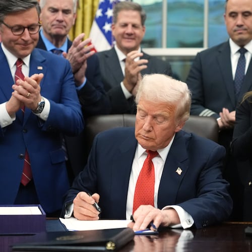 President Donald Trump signs the funding bill to reopen the government, in the Oval Office of the White House, Wednesday, Nov. 12, 2025, in Washington. (AP Photo/Jacquelyn Martin)