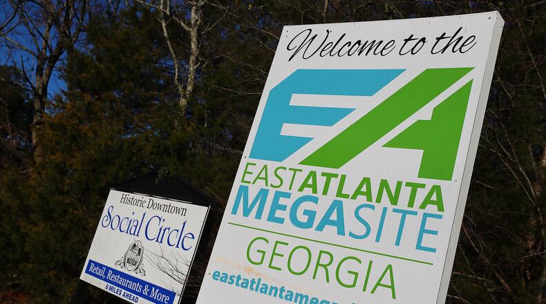 An East Atlanta Megasite sign marking the Rivian project site sits next to sign for the historic downtown of Social Circle, Georgia, on Tuesday, Jan. 18, 2022. (Curtis Compton/Atlanta Journal-Constitution/TNS)