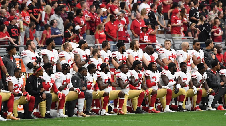 GLENDALE, AZ - OCTOBER 01: Members of the San Francisco 49ers kneel for the National Anthem before the start of the NFL game against the Arizona Cardinals at the University of Phoenix Stadium on October 1, 2017 in Glendale, Arizona. (Photo by Norm Hall/Getty Images)