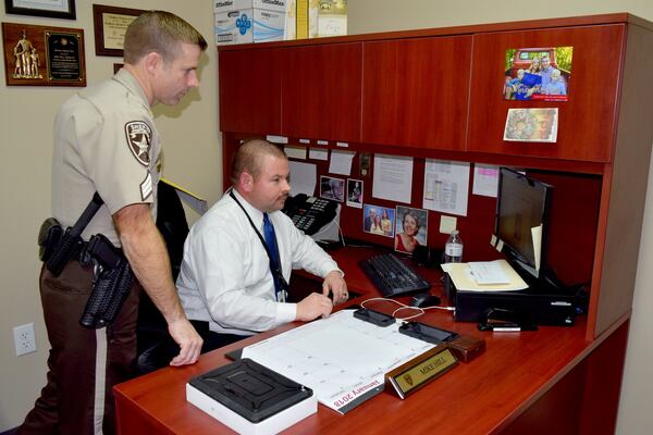 Sgt. Ashley Henson, left, was one of the first deputies to respond to Regan Wheeler’s home in October 2005. Lt. Mike Hill is now the lead detective in Wheeler’s homicide investigation. (Photo: Alexis Stevens/astevens@ajc.com)