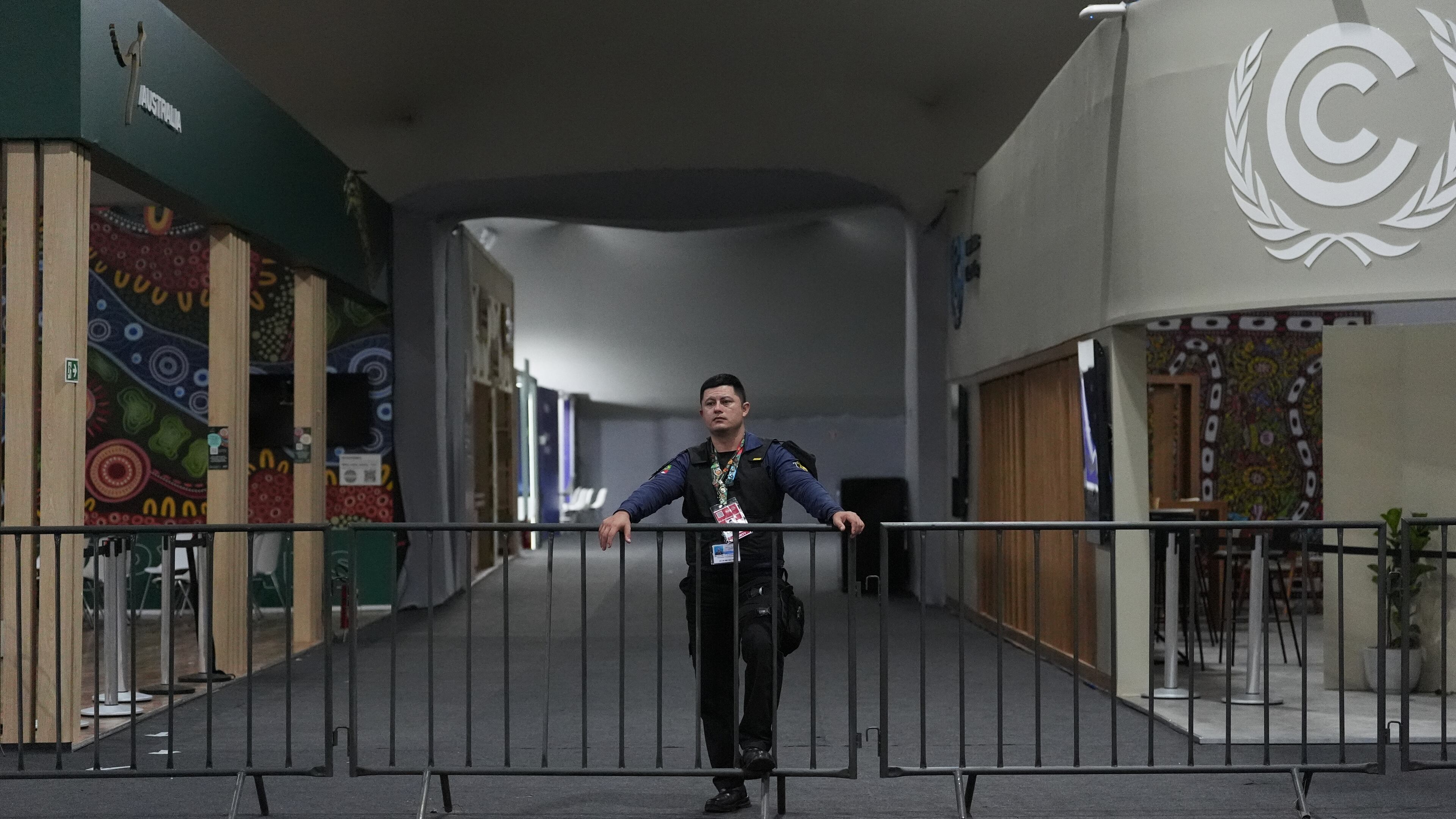 A member of security stands guard near the pavilion section of the COP30 U.N. Climate Summit as it remains closed following a fire earlier in the day, Thursday, Nov. 20, 2025, in Belem, Brazil. (AP Photo/Joshua A. Bickel)