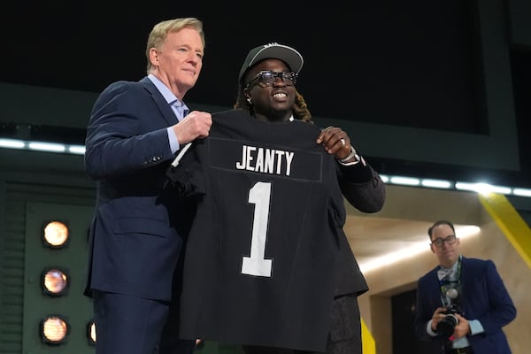 Boise State running back Ashton Jeanty, right, poses with NFL Commissioner Roger Goodell after being chosen by the Las Vegas Raiders with the sixth overall pick during the first round of the NFL football draft, Thursday, April 24, 2025, in Green Bay, Wis. (AP Photo/Jeff Roberson)