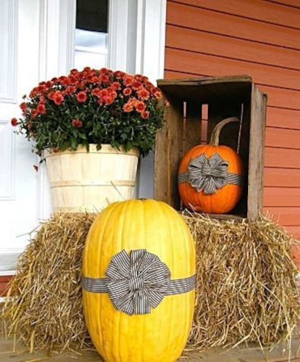 Tie a ribbon around a pumpkin for a simple outdoor display.