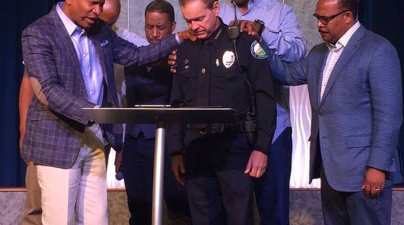 Roswell Police Department’s Chief Rusty Grant and leaders from Eagles Nest Church and Zion Missionary Baptist join for prayer following recent events, including the Dallas shooting that left five of 12 injured officers dead after a sniper opened fire during a peaceful protest against police violence on July 7, 2016.