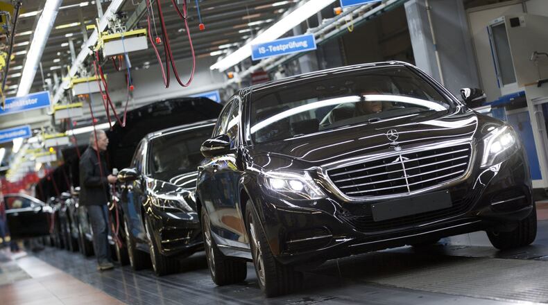 In this Jan. 28, 2015 file photo, a Mercedes-Benz AG employee checks a S-Class model at the plant in Sindelfingen, Germany. The S-Class is among the vehicles included in a potential class-action lawsuit against the automaker for climate control systems that emit a foul odor. (AP Photo/Matthias Schrader, File)