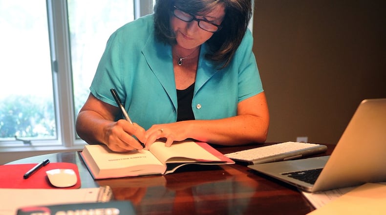 Karen Handel signs copies of her new book, “Planned Bullyhood,” at her Roswell home Thursday.