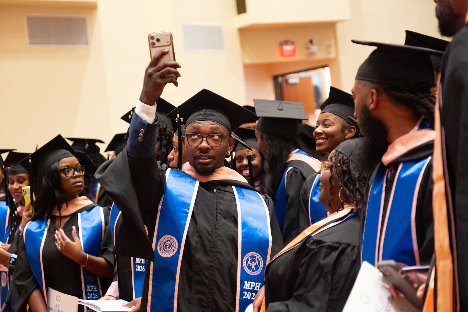 Jonathan Carey, who earned a master’s of public health, shoots a photo before the start of the graduation ceremony for Morehouse School of Medicine students on Saturday, May 16, 2026, in Atlanta. (Ben Gray for the AJC)