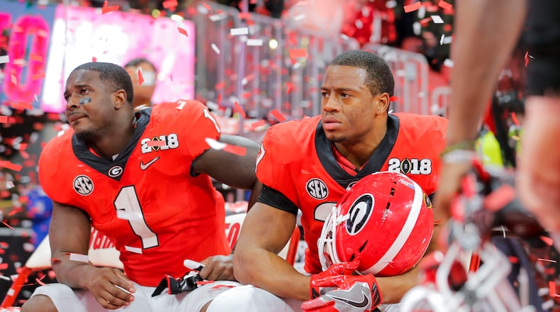01/08/2018 -- Atlanta, GA - Georgia Bulldogs running back Sony Michel (1) and Georgia Bulldogs running back Nick Chubb (27) are emotional following a loss to the Alabama Crimson Tide during the College Football Playoff National Championship at Mercedes-Benz stadium in Atlanta, Monday, January 8, 2018. The Georgia Bulldogs lost to the Alabama Crimson Tide in OT, 23-26. ALYSSA POINTER/ALYSSA.POINTER@AJC.COM
