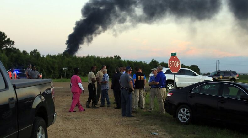 Emergency officials respond to the site of a military plane crash near Itta Bena, Miss., on Monday, July 10, 2017. (Elijah Baylis/The Clarion-Ledger via AP)