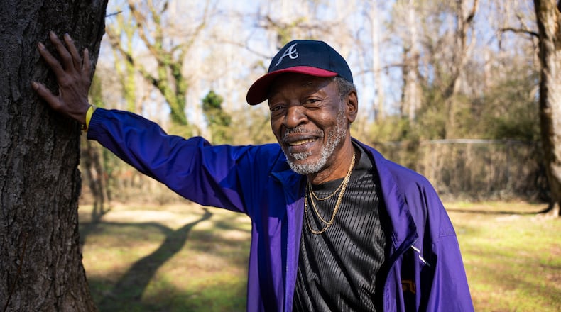 Fernando Jones touches the tree he fell from as a child at the site of the old Carrie Steele-Pitts Home in Atlanta, Georgia on Monday, Feb, 3, 2025. (Olivia Bowdoin for the AJC).