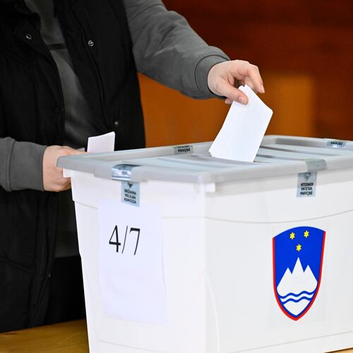 People casts her vote at a polling station for parliamentary elections in Arnace, Slovenia, on Sunday, March 22, 2026. (AP Photo/Denes Erdos)