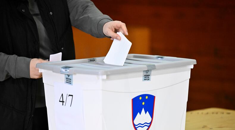 People casts her vote at a polling station for parliamentary elections in Arnace, Slovenia, on Sunday, March 22, 2026. (AP Photo/Denes Erdos)