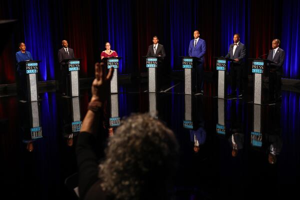 A signal for time is given as Democratic candidates for governor Keisha Lance Bottoms (from left), Olu Brown, Amanda Duffy, Geoff Duncan, Jason Esteves, Derrick Jackson and Michael Thurmond conclude the Atlanta Press Club Loudermilk-Young debates at Georgia Public Broadcasting last week. (Arvin Temkar/AJC)