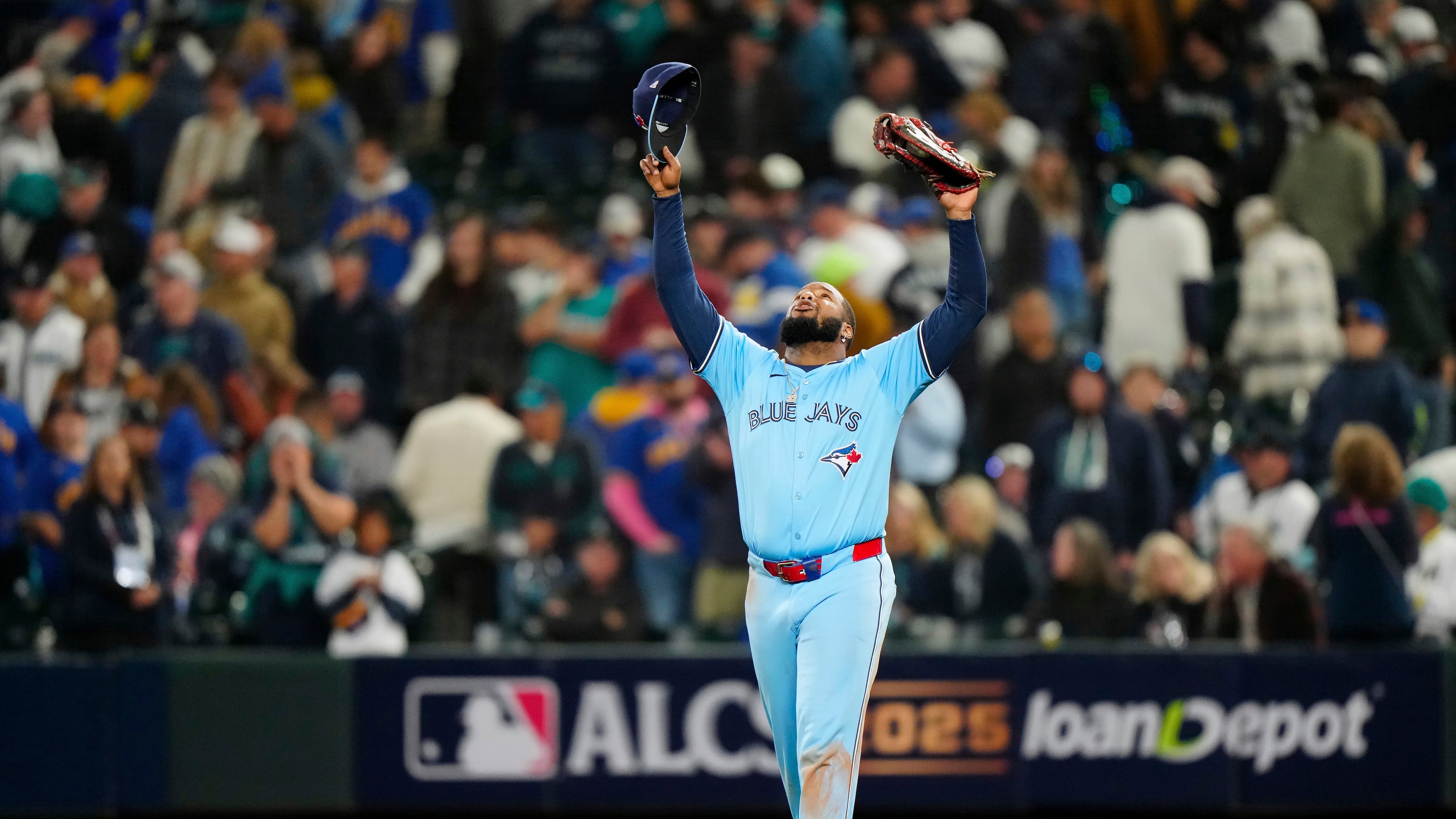 Toronto Blue Jays' Vladimir Guerrero Jr. (27) celebrates after the final out to defeat the Seattle Mariners in Game 3 of baseball's American League Championship Series, Wednesday, Oct. 15, 2025, in Seattle. (Frank Gunn/The Canadian Press via AP)