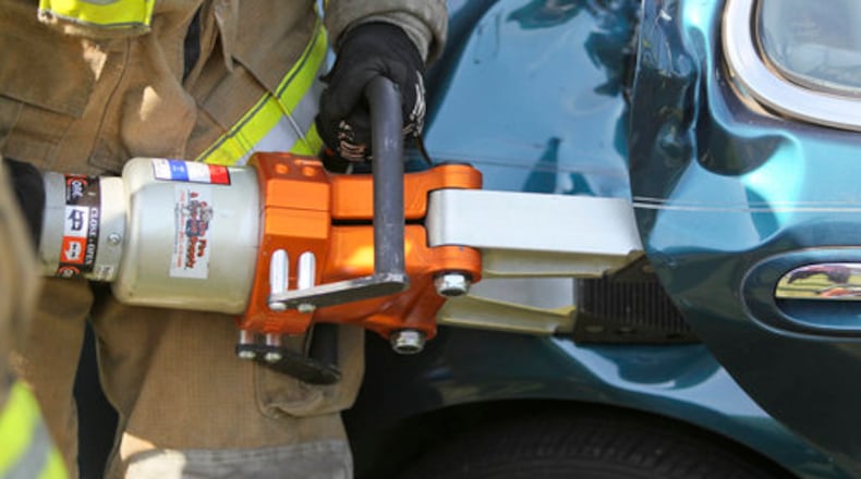 Atlanta firefighters use the "jaws of life" to pry open the doors and perform a mock extrication from a wrecked car.