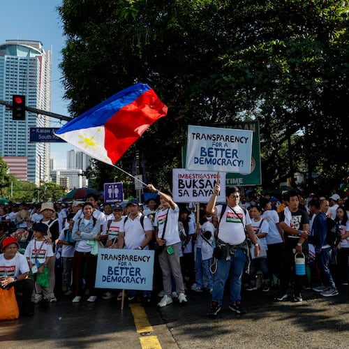 Members of the religious sect Iglesia Ni Cristo (Church of Christ) hold placards during a three-day anti-corruption rally at Manila's Rizal Park, Philippines on Sunday, Nov. 16, 2025. (AP Photo/Mark Cristino)