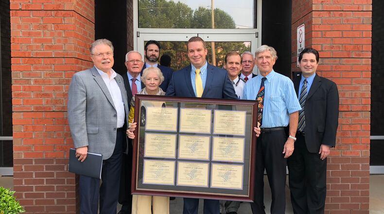 Nine standards certificates presented to the Gwinnett Board of Health (Pictured L-R) Peachtree Corners Mayor Mike Mason, Alvin Wilbanks, Joseph Sternberg, Louise Radloff, Jason Reagan, Dr. Alan Bier, Dr. Lloyd Hofer, Dr. Earl Grubbs, Chris Smith. Courtesy Gwinnett, Newton and Rockdale Health Departments