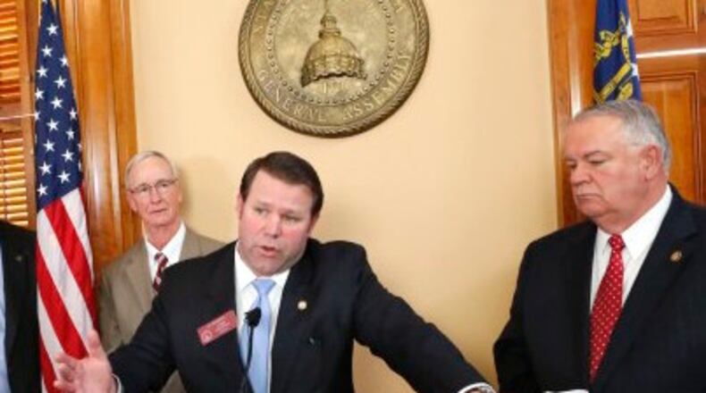 January 28, 2015 - Atlanta - House Transportation Committee Chairman Jay Roberts (at podium) and Speaker David Ralston (right), outlined the transportation plan at a news conference Wednesday afternoon. Behind them is Appropriations Committee Chairman Terry England (left), R - Auburn, Matt Hatchett, R - Dublin and Larry O`Neal, R - Bonaire. Republican leaders in the state House on Wednesday unveiled their plan for funding transportation improvements. Speaker David Ralston, R-Blue Ridge, along with House Transportation Committee Chairman Jay Roberts, R - Ocilla, outlined the plan at a news conference Wednesday afternoon. BOB ANDRES / BANDRES@AJC.COM House Transportation Chair Jay Roberts, center, describes a new transportation funding proposal Wednesday as House Speaker David Ralston, right, and Majority Leader Larry O'Neal look on. BOB ANDRES / BANDRES@AJC.COM