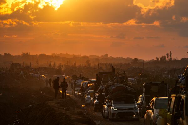 FILE - Displaced Palestinians, traveling in vehicles, wait in line to pass through a security checkpoint at the Netzarim corridor as they make their way from central Gaza to their homes in the northern Gaza Strip, Monday, Feb. 10, 2025. (AP Photo/Abdel Kareem Hana, File)
