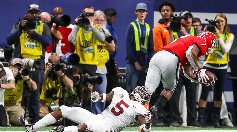 12/01/2018 -- Atlanta, Georgia -- Georgia Bulldogs running back D'Andre Swift (7) runs out of a tackle to complete a touchdown during the first half of the SEC Championship game at Mercedes-Benz Stadium in Atlanta, Saturday, December 1, 2018. (ALYSSA POINTER/ALYSSA.POINTER@AJC.COM)