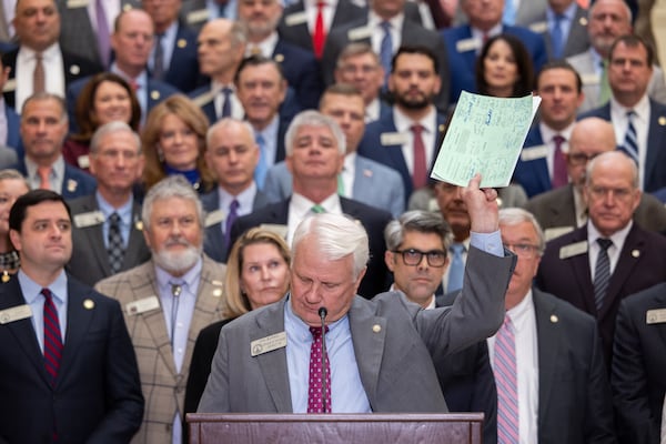 House Speaker Jon Burns held up proposed property tax relief legislation during a news conference at the Capitol in Atlanta in January. (Arvin Temkar/AJC)